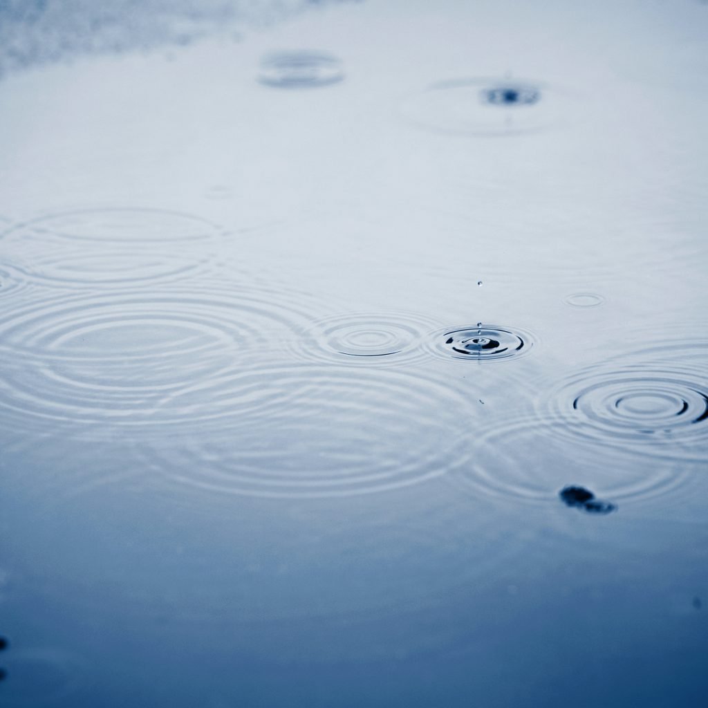 Rain drops on puddle