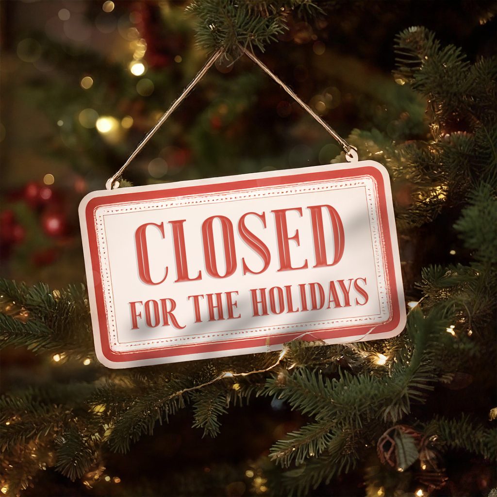 Closed for the Holidays sign hanging from tree